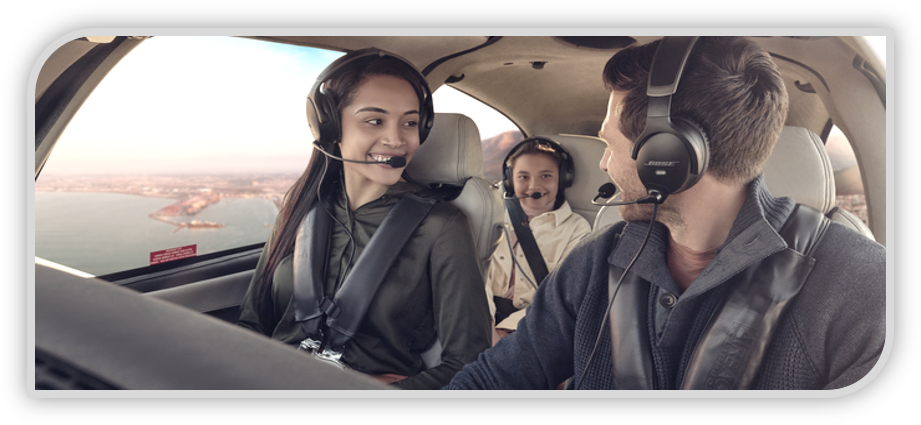 A man flying a small private plane with his family in the passenger seats